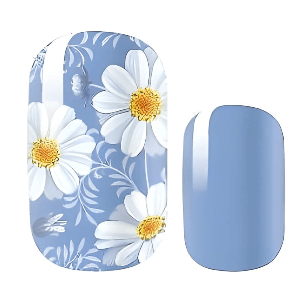 Blue nail wraps featuring white daisy flowers with yellow centres for floral nail art design