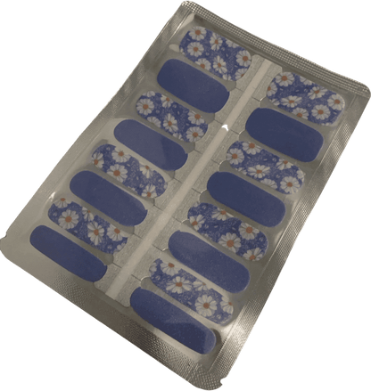 Blue daisy floral nail wraps with white flowers in packaging for at-home manicure