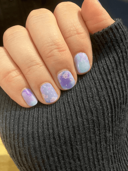 Holy Classics non-UV nail wraps in blue-purple marble with pastel floral accents, glossy finish