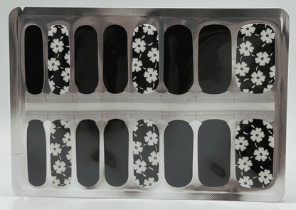 Non-UV nail wrap sheets featuring black base with white daisy floral pattern design