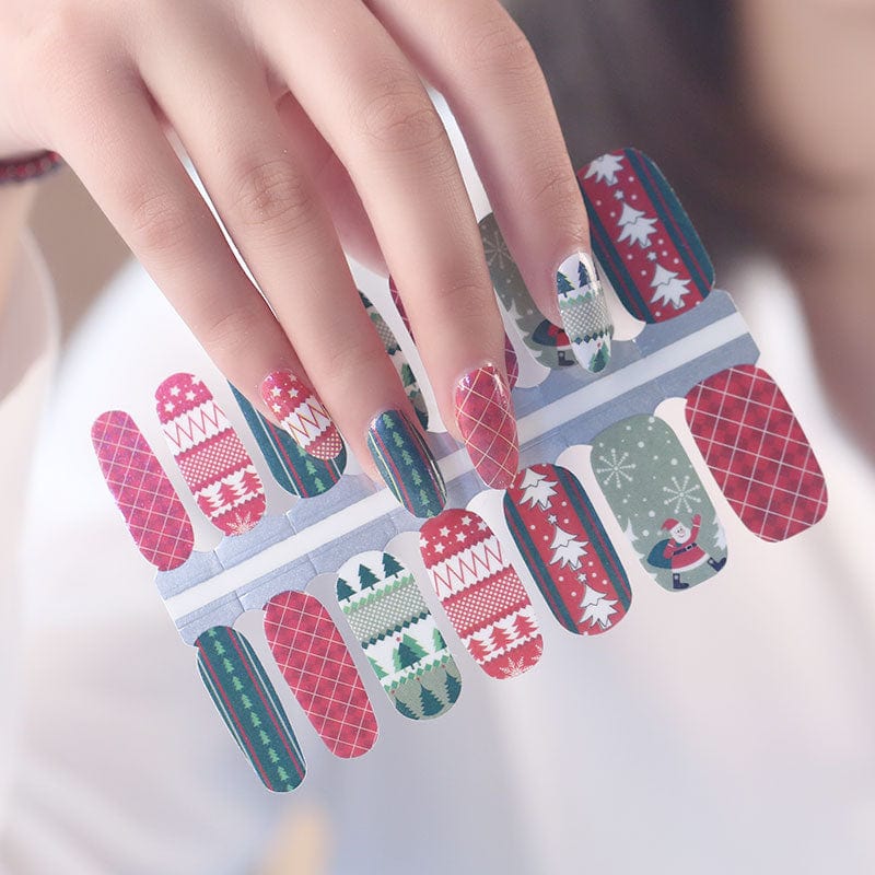 Holy Classics nail wraps in red and green with Christmas trees, plaid, Santa and snowflakes