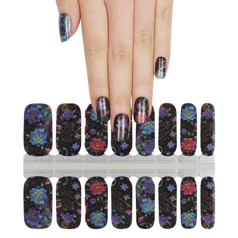 Dark floral nail wraps with colourful blooms on black base, hand wearing matching manicure
