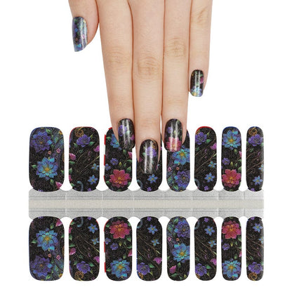 Dark floral nail wraps with colourful blooms on black base, hand wearing matching manicure