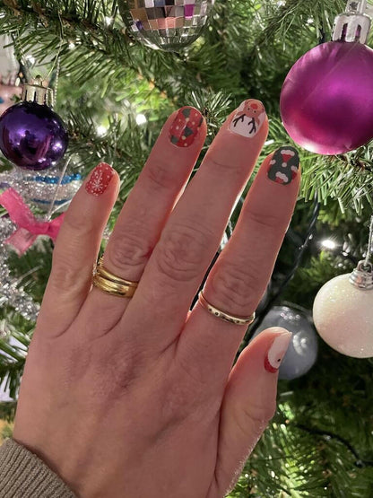 Holy Classics non-UV nail wraps with festive reindeer, tree and Santa designs on red and green