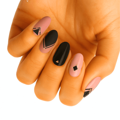 Matte mauve and glossy black nail wraps with gold-outlined geometric shapes
