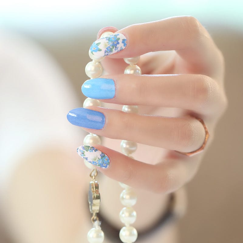Holy Classics nail wraps in glossy blue shades with white floral accent nails