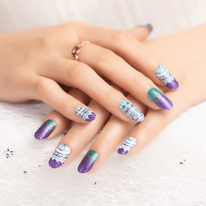 Purple and teal glitter gradient nail wraps on hands showing ombre sparkly manicure design