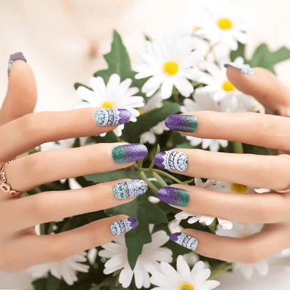 Sparkly purple and turquoise gradient nail wraps on hands with white daisy flowers background