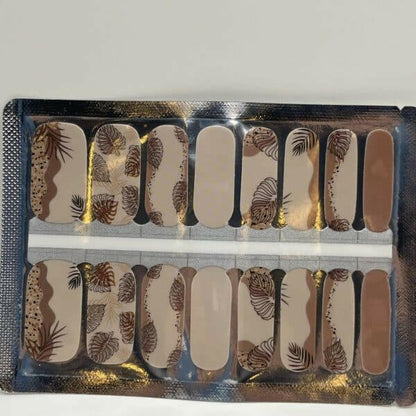 Brown palm leaf pattern nail wraps with nude base in packaging