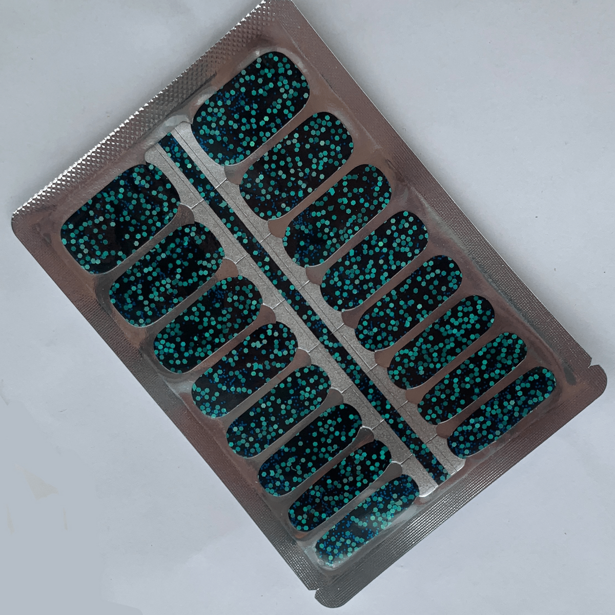 Complete sheet of dark teal glitter nail wraps with disco ball finish