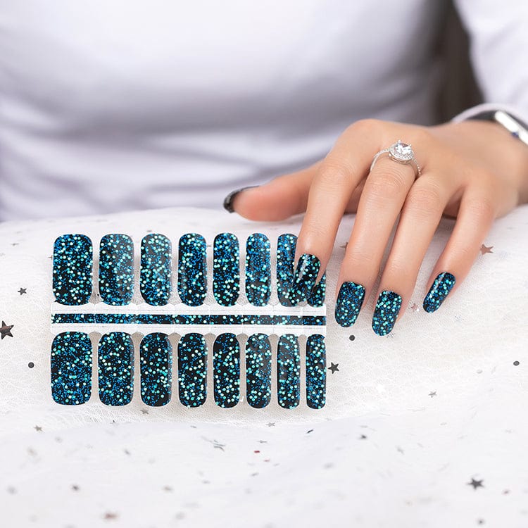 Teal glitter nail wraps sheet with hand showing disco sequin manicure design