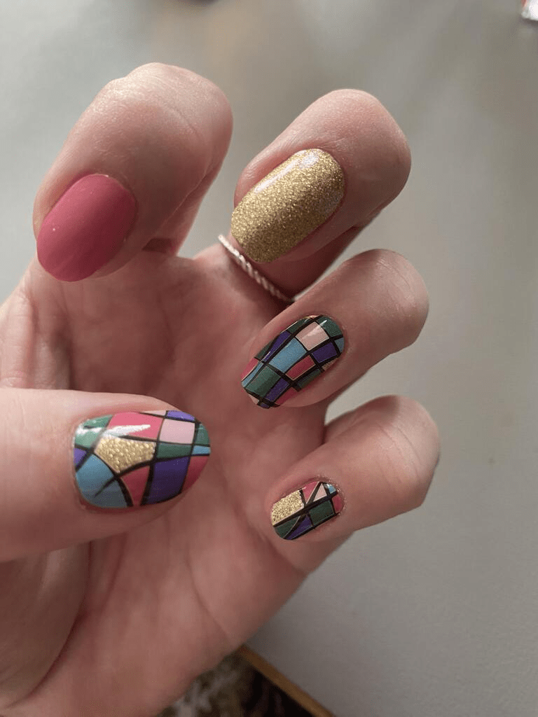 Geometric mosaic nail art wraps in pink blue gold with glitter finish on hand