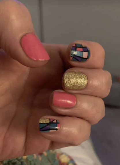 Pink and gold glitter non-UV nail wraps with colourful geometric mosaic pattern on hand