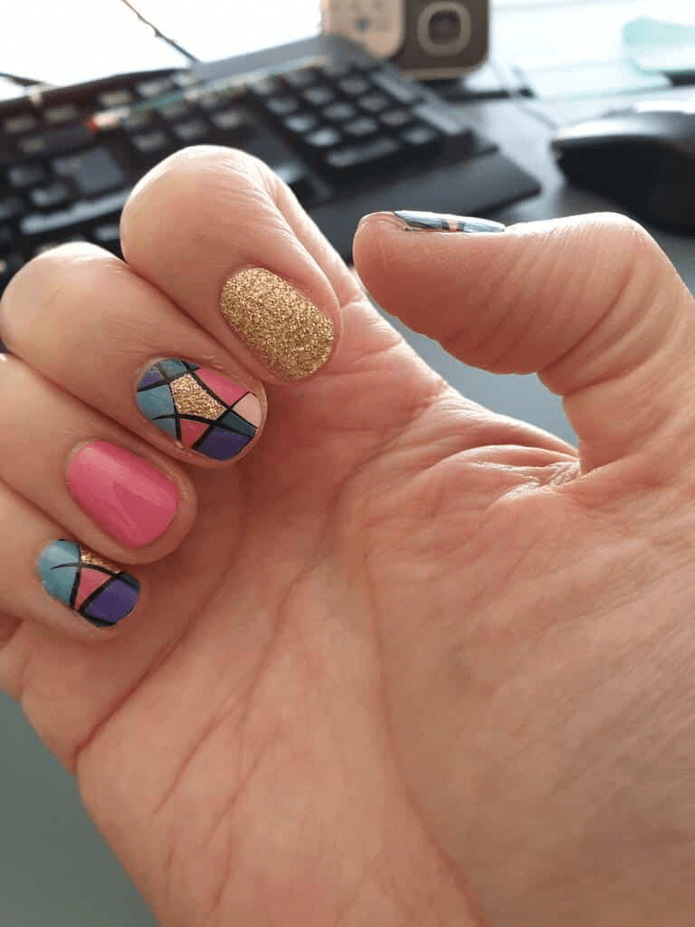 Stained glass style nail wraps featuring pink gold and multicoloured mosaic design on hand