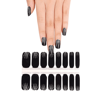 Black X-ray skeleton nail wraps displayed on hand with complete set showing Halloween nail art