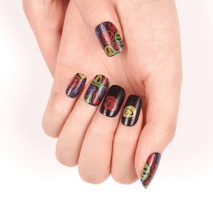 Hand displaying colourful smiley face nail art wraps with bold neon rainbow patterns