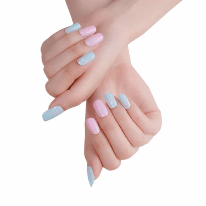 Pastel blue and pink nail wraps with scattered dot pattern, square tips