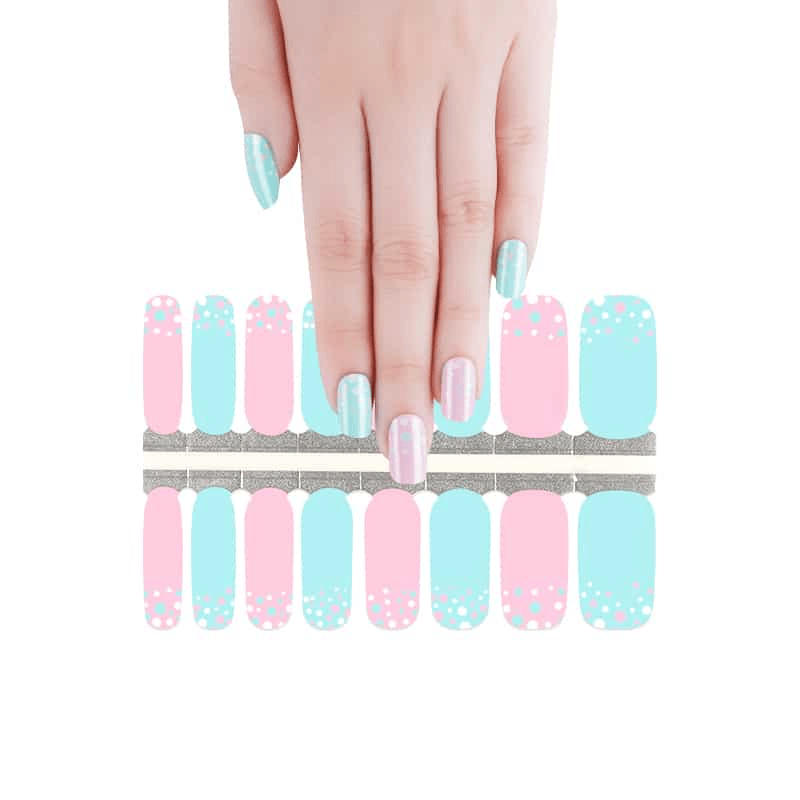 Hand selecting from sheet of pastel polka dot nail wraps in blue and pink