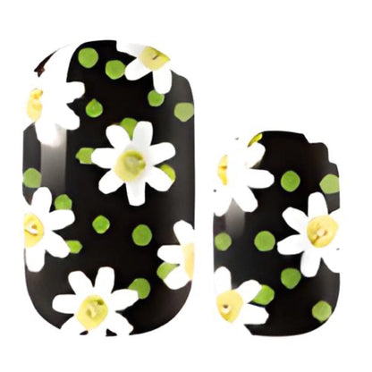 Black floral nail wraps featuring white daisies with yellow centres and green polka dots