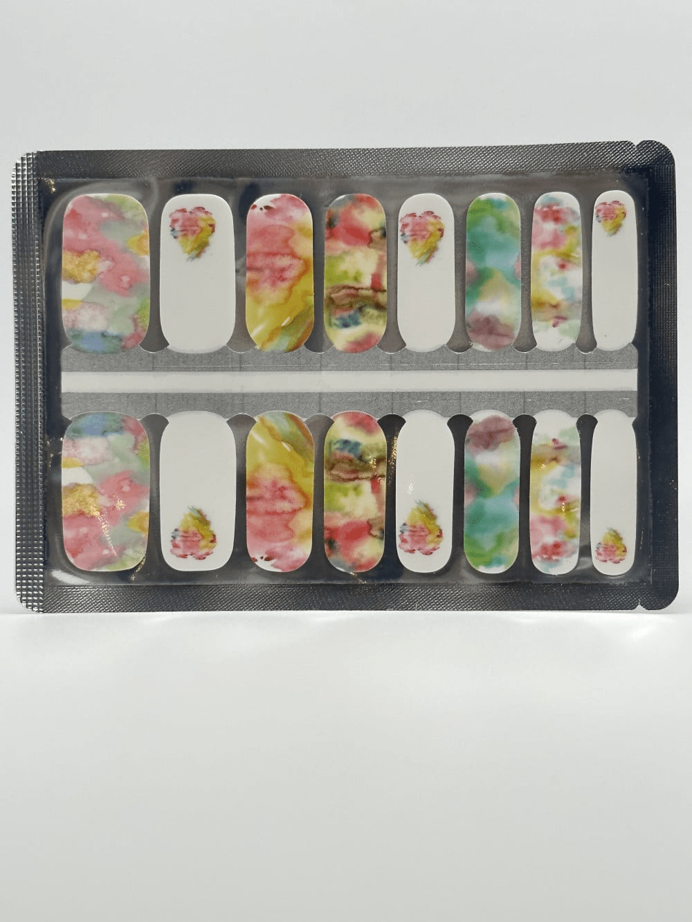 Multicolour watercolour nail wraps in packaging with abstract painterly pastel design