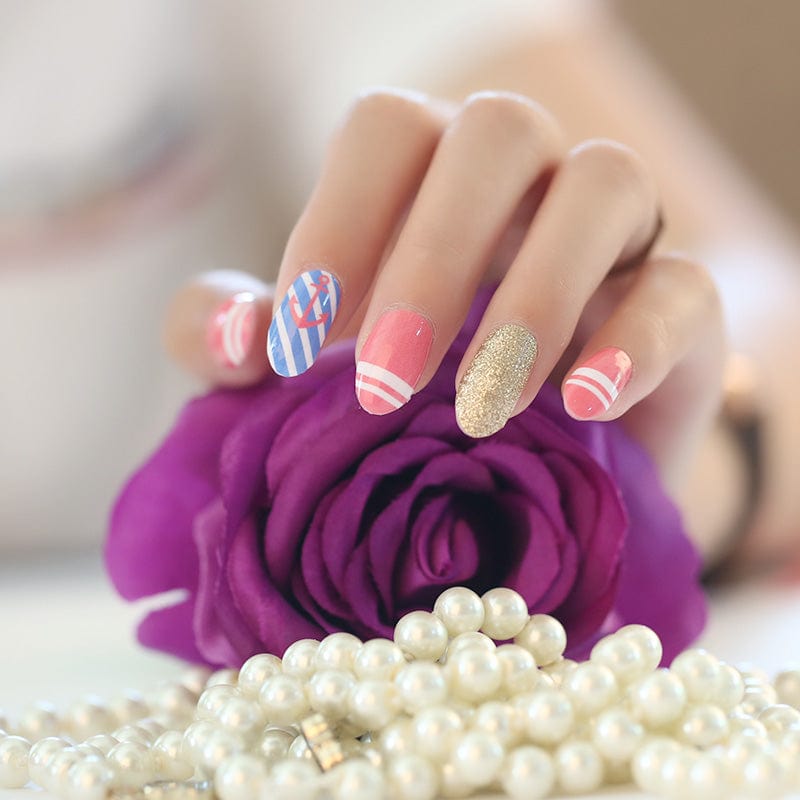Colourful nail art featuring blue stripes, pink designs and gold glitter on hand with purple rose