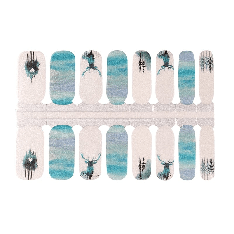 Blue and grey watercolour nail wraps featuring woodland stag and tree silhouettes