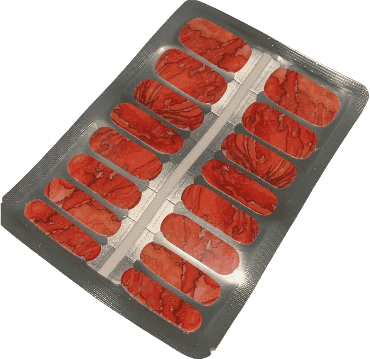Red nail wraps with marbled, veined stone-like texture in sheet packaging