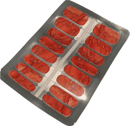 Red nail wraps with marbled, veined stone-like texture in sheet packaging