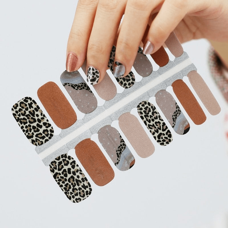 Non-UV nail wraps sheet featuring leopard print patterns in brown caramel neutral colours