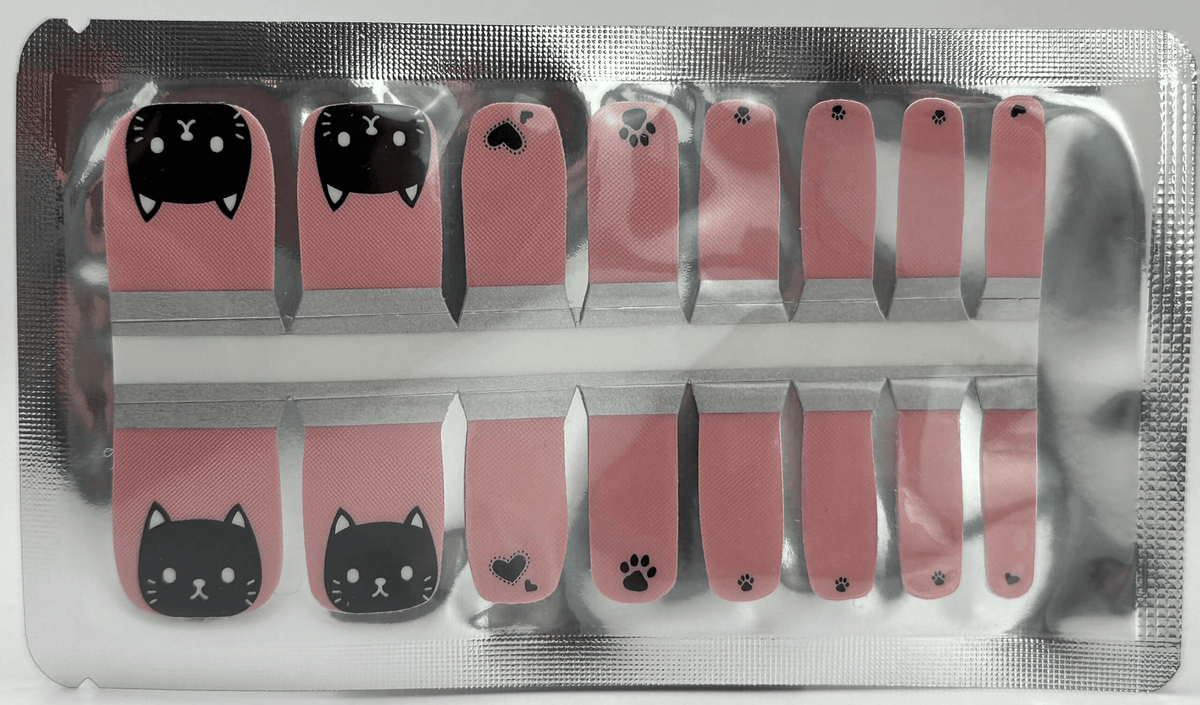 Pink and black cat themed pedicure nail wraps with kawaii feline faces and paw prints