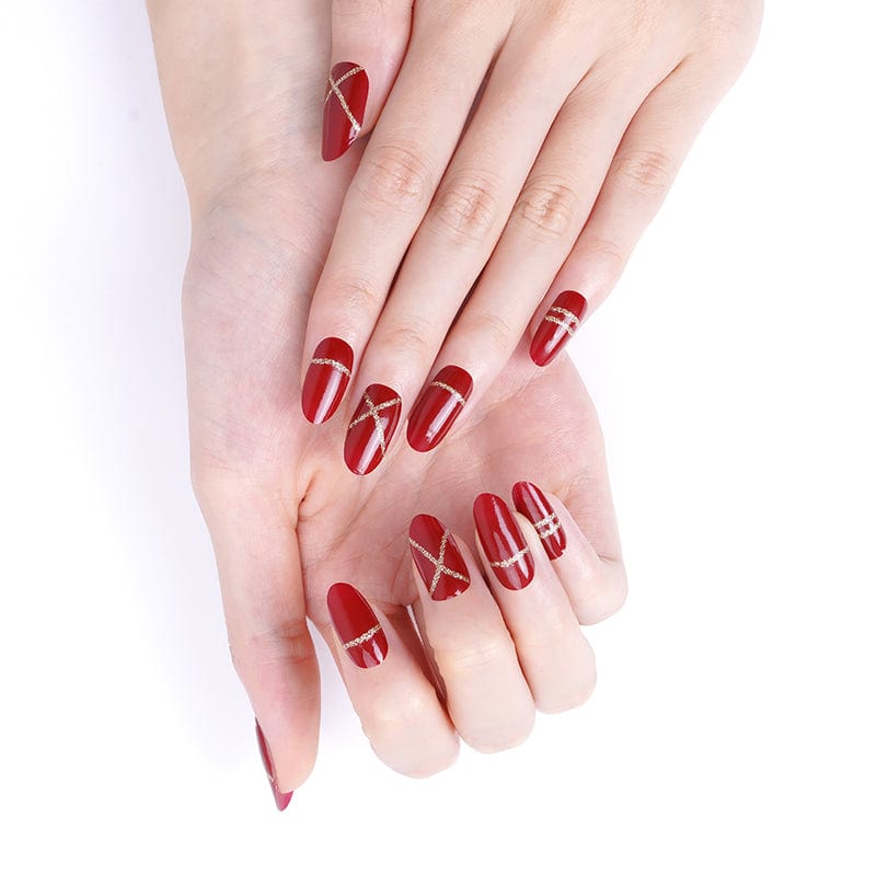 Burgundy nail wraps with gold accent lines displayed on hands for Christmas nail art