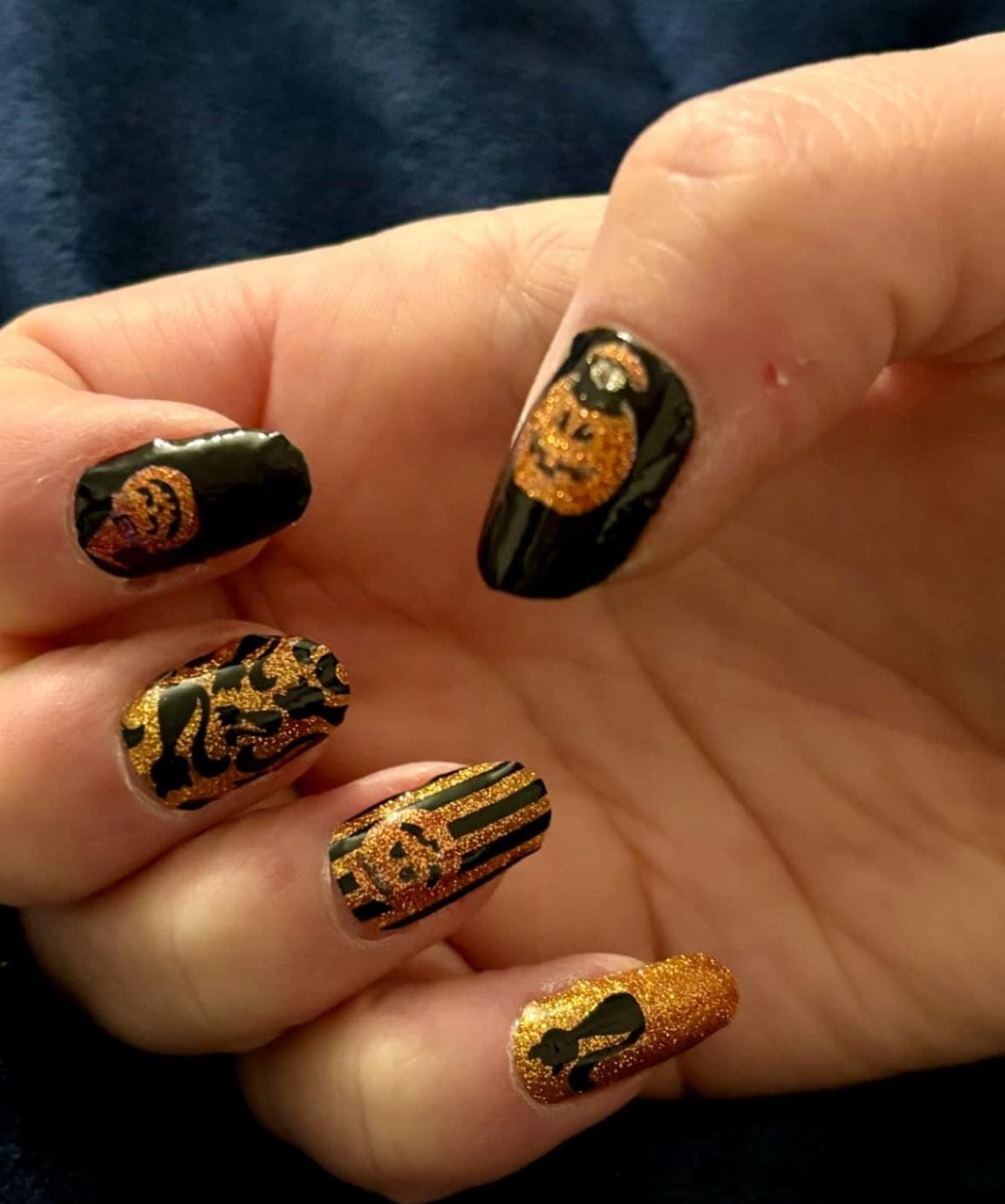 Black and orange glitter nail wraps with pumpkin faces, cat silhouette and stripe design