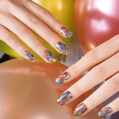Manicured hands displaying multicoloured holographic nail wraps with mermaid scale design