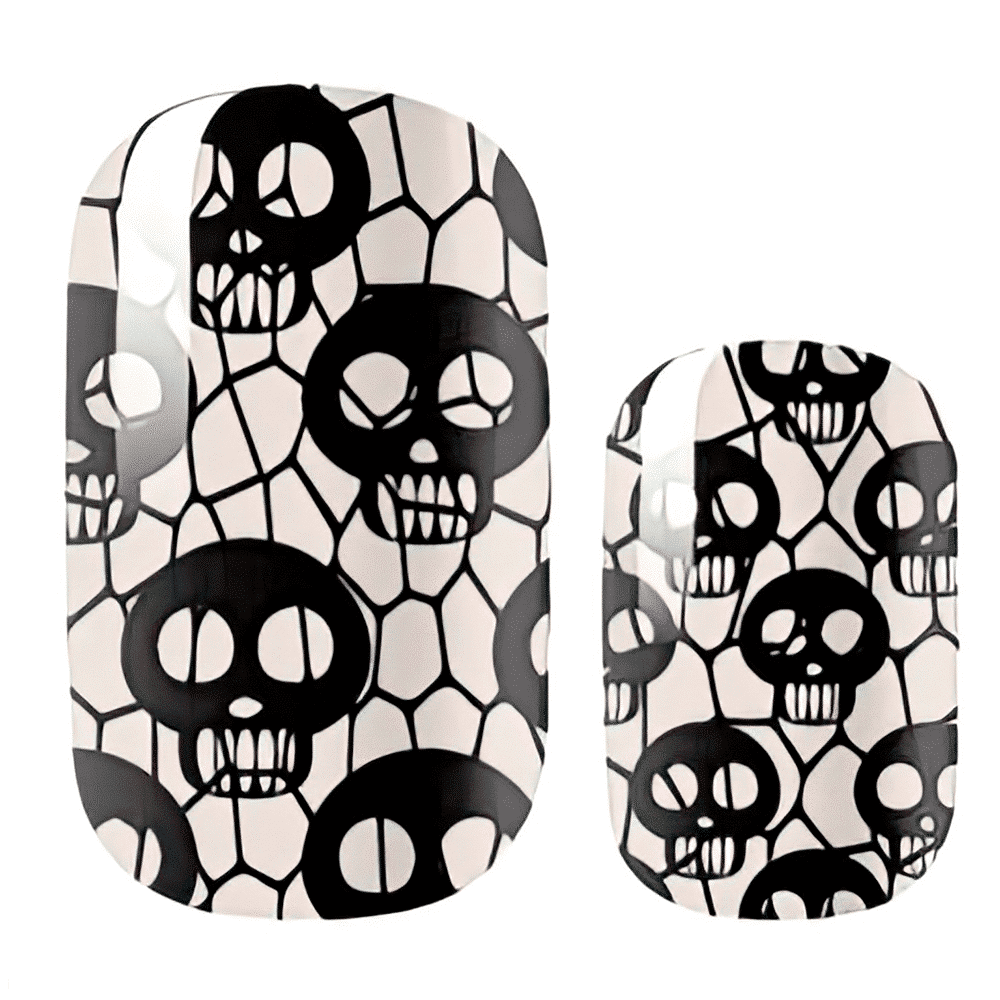 Nail wraps with black skulls on a cream crackled fishnet pattern, glow-in-the-dark finish
