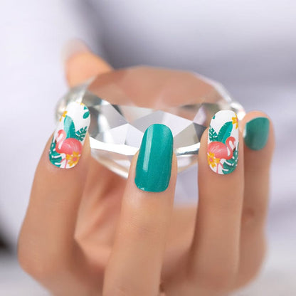 Hand holding crystal showing teal and tropical flamingo nail wraps at-home manicure design