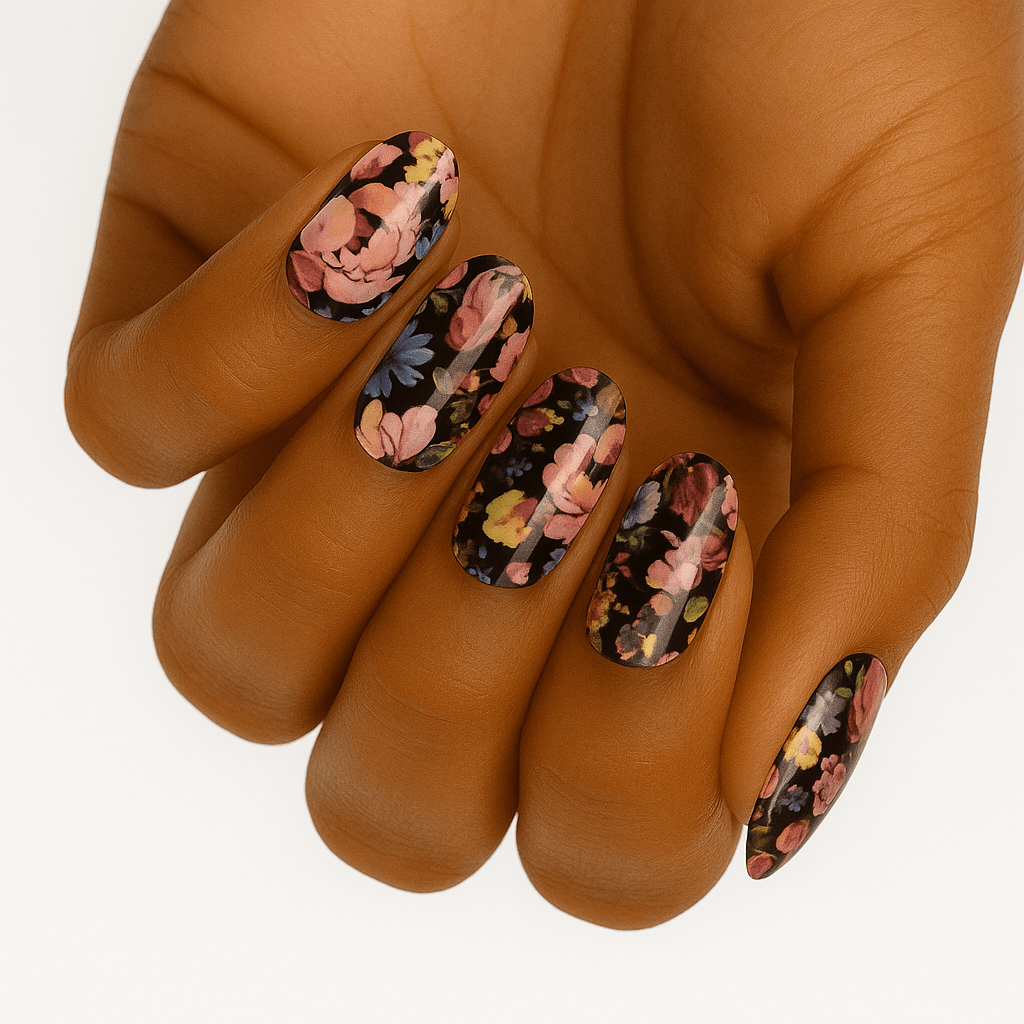 Dark floral nail wraps on hand featuring pink roses on black background