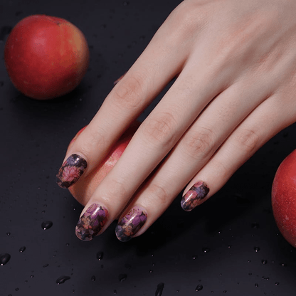 Moody floral nail art wraps on hand with vintage pink roses and dark base