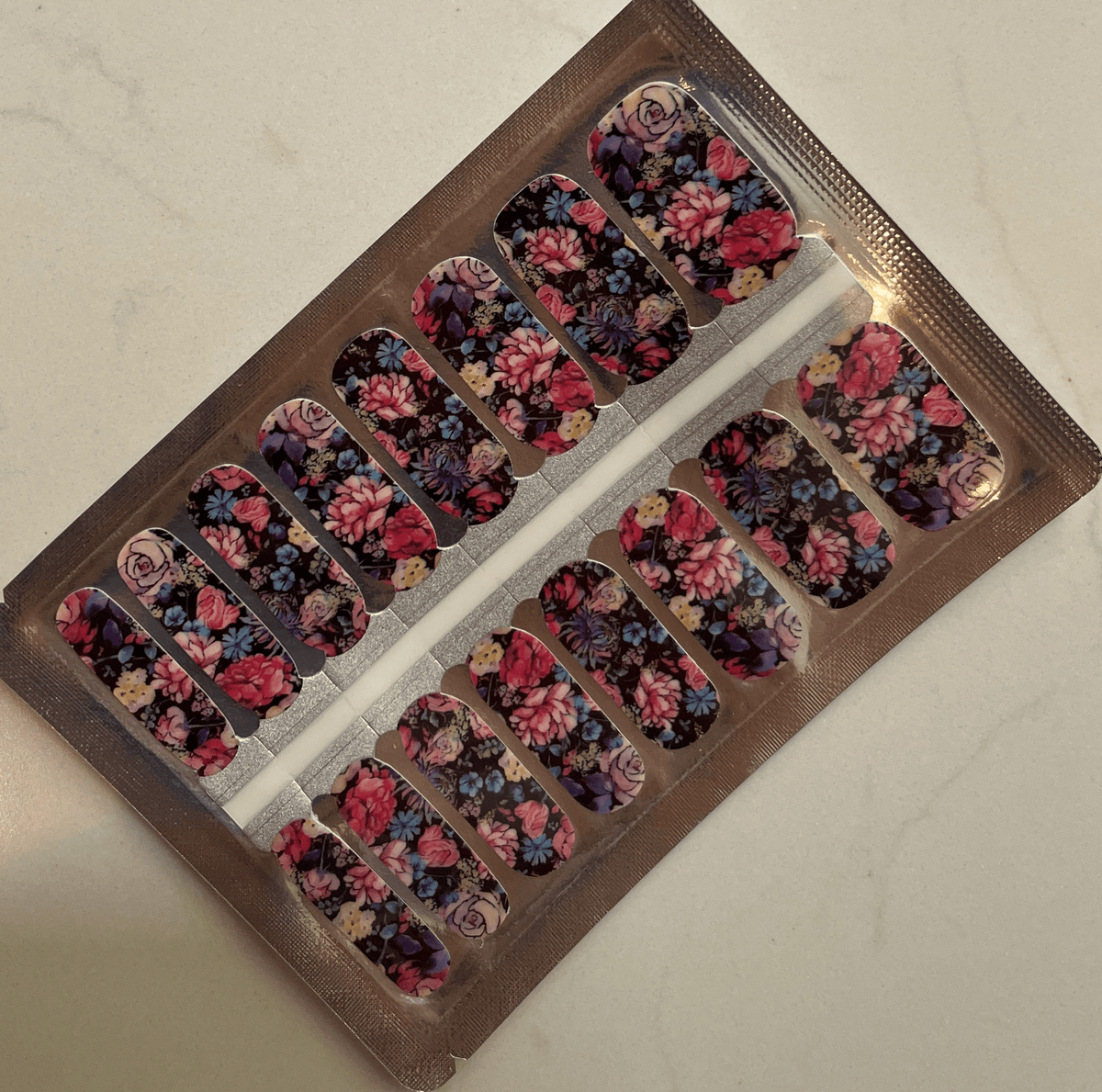 Non-UV nail wraps in packaging showing vintage floral design with pink roses