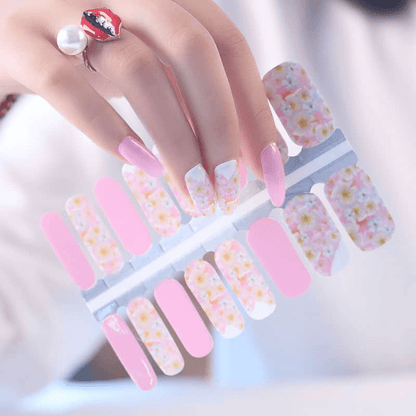 Non-UV nail wraps featuring pink and white floral daisy design on fingernails