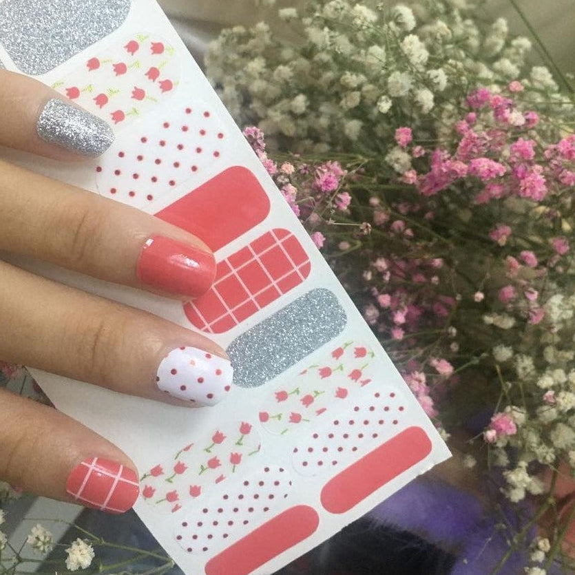 Nail wraps in coral, silver glitter, white with polka dots and tulip floral prints