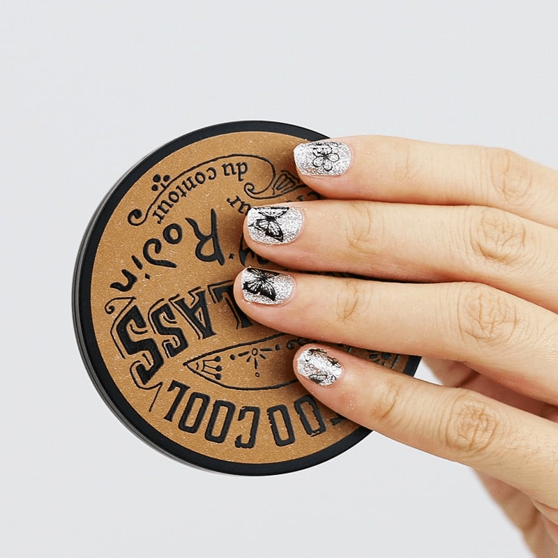 Silver glitter nail wraps with black butterfly outline design on fingers