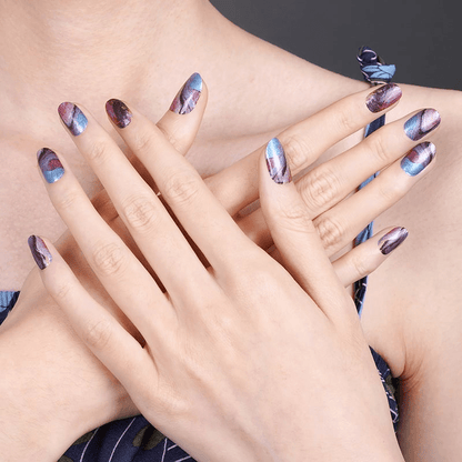 Multiple hands showcasing marble effect nail wraps with organic blue purple pink swirl designs