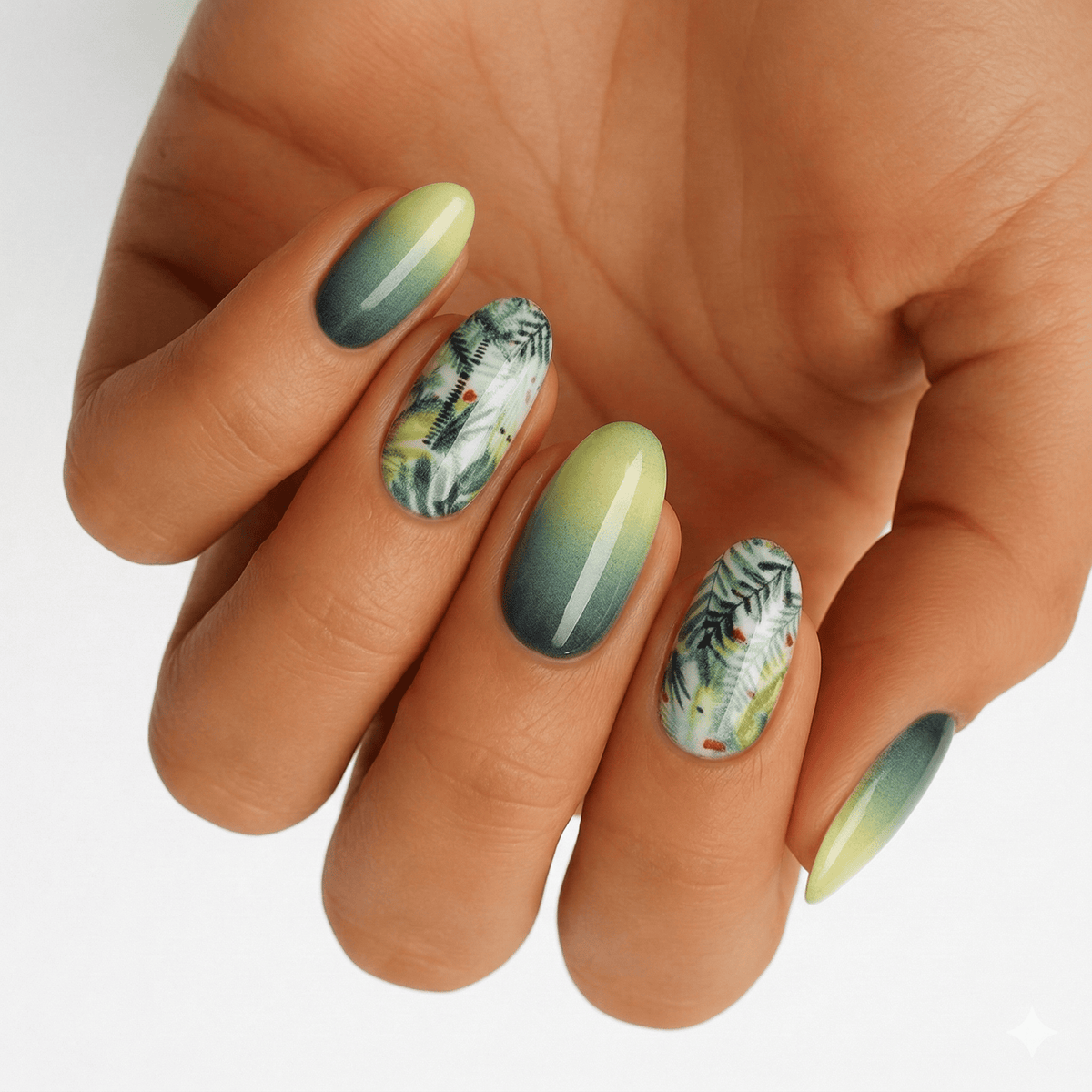 Green-yellow ombré nail wraps with fern leaf print and speckled accents, glossy finish