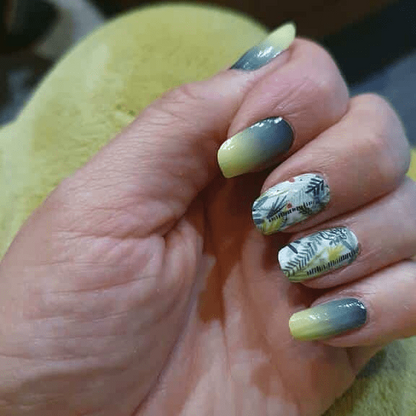 Green ombre nail art with leaf pattern botanical nail wraps on hand