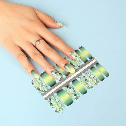 Forest green gradient nail wraps with botanical prints next to hand application