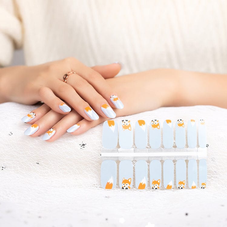 Cute fox nail wraps on hand with grey and orange cartoon design