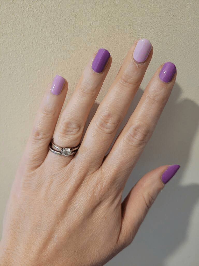 Purple mauve nail wraps on hand showing dusty purple manicure for professional nail art