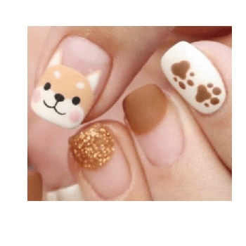 Close-up fox nail art with brown paw prints and gold glitter accent nail