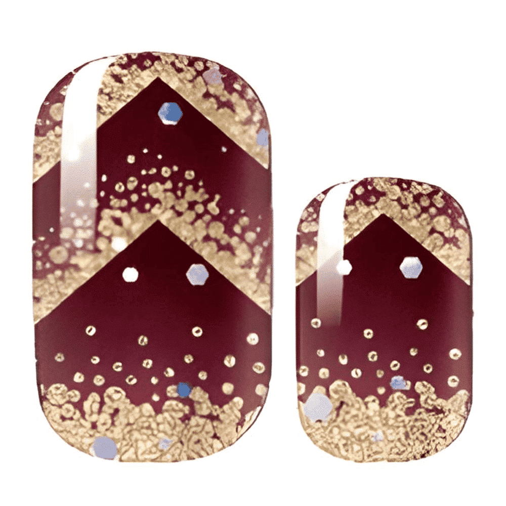 Burgundy nail wraps with gold chevron pattern and glitter dots showing festive nail design
