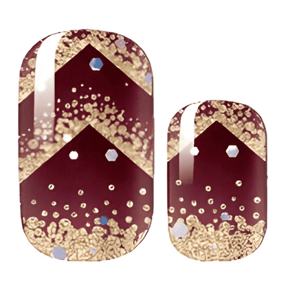 Burgundy nail wraps with gold chevron pattern and glitter dots showing festive nail design